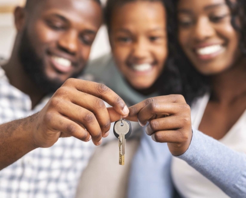 family showing off their new house keys